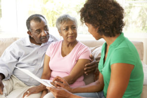 caregiver talking to a couple