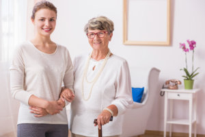 caregiver holding the hands of elderly patient