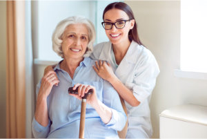 caregiver holding the shoulder of elderly patient